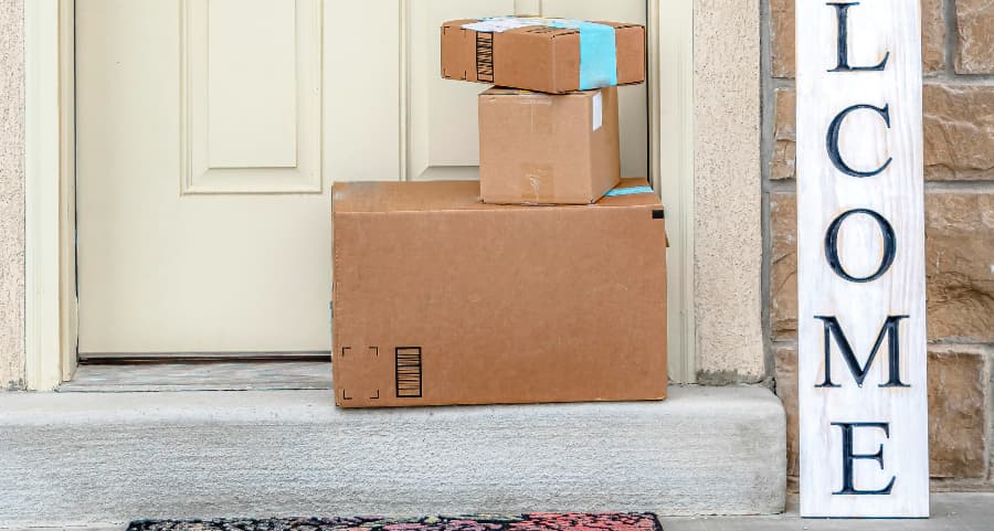 Boxes by the door of a residence with a welcome sign in Ventura